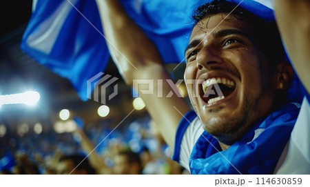a soccer fan, their eyes shining with passion as they raise their scarf high in the air a soccer fan, their eyes shining with passion as they raise their scarf high in the air 114630859