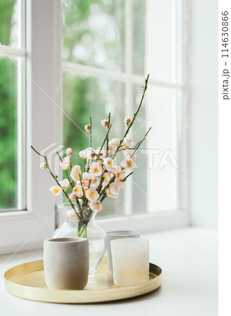 Vase with flowers and candles on the windowsill. March 8, Women's Day. Mother's Day. It's a beautiful romantic morning. Selective focus, spring summer seasonal concept 114630866