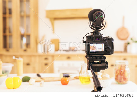 Stylish kitchen with minimalist interior. Professional camera takes photo of blurred kitchen in daylight. food blog 114630869