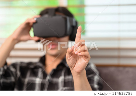 Select focus on hand. Man wearing vr headset fingers touching something Select focus on hand. Man wearing vr headset fingers touching something 114632785