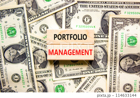 Portfolio management symbol. Concept words Portfolio management on beautiful wooden block. Beautiful dollar bills background. Dollar bills. Business Portfolio management concept. Copy space. 114633144