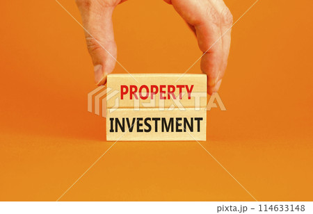 Property investment symbol. Concept words Property investment on beautiful wooden block. Beautiful orange paper background. Businessman hand. Business Property investment concept. Copy space. Property investment symbol. Concept words Property investment on beautiful wooden block. Beautiful orange paper background. Businessman hand. Business Property investment concept. Copy space. 114633148