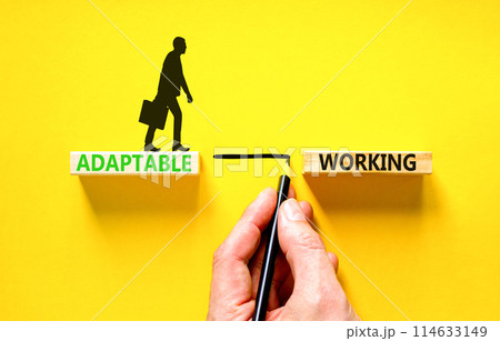 Adaptable working symbol. Concept words Adaptable working on beautiful wooden block. Businessman icon. Businessman hand. Beautiful yellow background. Business Adaptable working concept. Copy space. Adaptable working symbol. Concept words Adaptable working on beautiful wooden block. Businessman icon. Businessman hand. Beautiful yellow background. Business Adaptable working concept. Copy space. 114633149