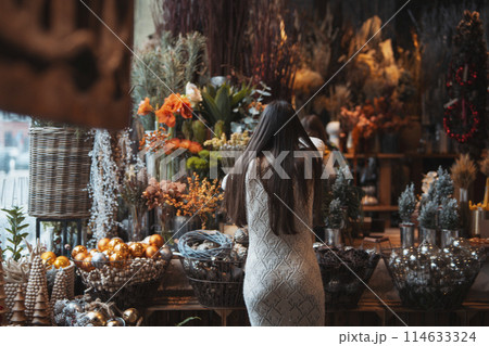 Aesthetic New Year's decorations creating a festive atmosphere at the store counter. Aesthetic New Year's decorations creating a festive atmosphere at the store counter. 114633324
