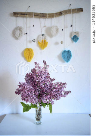 a bouquet of lilacs in a crystal vase in the interior 114633665