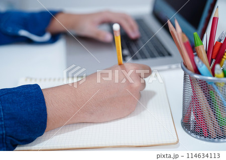 Asian teenage student write homework with laptop computer, learning university education concept. 114634113