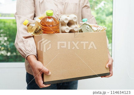 Foodstuffs in donation box for volunteer to help people. Foodstuffs in donation box for volunteer to help people. 114634123
