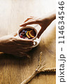 Male and female hand reaching for a cup of tea 114634546