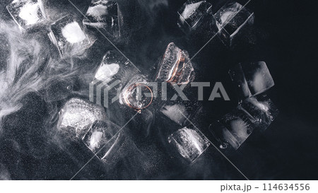 Frozen rings in ice with water and smoke on black background 114634556
