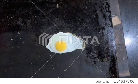 Delicious Fried Egg Cooking on Hot Griddle Overhead View 114637306