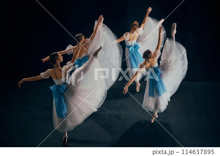 Four ballerinas in white and blue costumes performing on stage, each dancer showcasing exquisite balance of strength and grace. Four ballerinas in white and blue costumes performing on stage, each dancer showcasing exquisite balance of strength and grace. 114637895