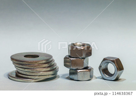 Joiner's accessories. Stacks of metal screw washers and nuts iso 114638367