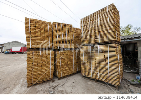 Stack of new wooden boards and studs at the lumber yard. Wooden plates on piles for furniture materials 114638414