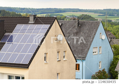 Renewable clean green energy saving efficient solar panels on suburban house roof. 114638435