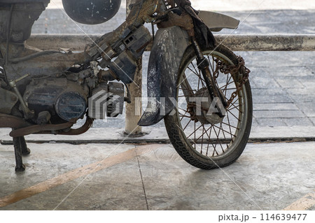 The Remains of an Old, Non-Functional Motorcycle Parked in a Motorcycle Graveyard, Awaiting Destruction The Remains of an Old, Non-Functional Motorcycle Parked in a Motorcycle Graveyard, Awaiting Destruction 114639477