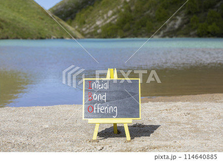 IBO initial bond offering symbol. Concept words IBO initial bond offering on beautiful yellow blackboard. Beautiful mountain lake background. Business IBO initial bond offering concept. Copy space. 114640885