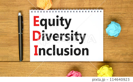 EDI equity diversity inclusion symbol. Concept words EDI equity diversity inclusion on white note. Beautiful wooden table wooden background. Business EDI equity diversity inclusion concept. Copy space 114640923