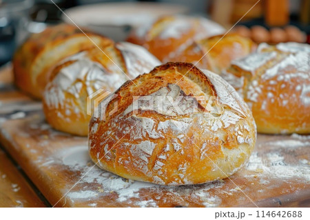 Artisanal Sourdough Bread Loaves on Rustic Wooden Board Artisanal Sourdough Bread Loaves on Rustic Wooden Board 114642688