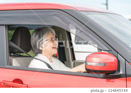 自動車の運転をする笑顔の高齢者ドライバーの女性 自動車の運転をする笑顔の高齢者ドライバーの女性 114645534