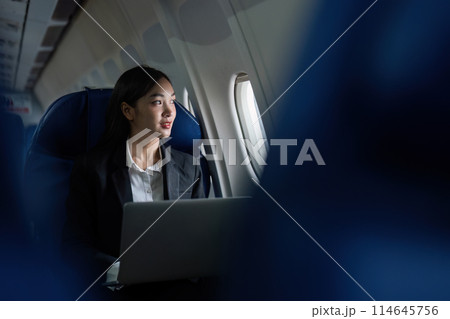 Beautiful Asian businesswoman working with laptop in aeroplane. working, travel, business concept 114645756
