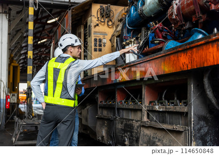 Team railway engineer Inspect repair project train diesel engine in maintenance center. Team railway engineer Inspect repair project train diesel engine in maintenance center. 114650848