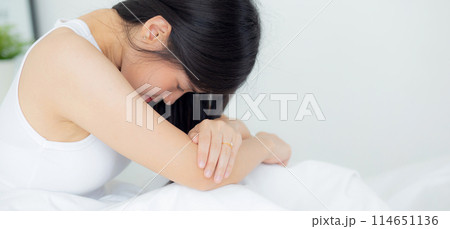 Young asian woman is depression and having mental problem sitting on bed. 114651136