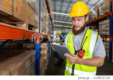 Male holding tablet quality control standing at machine of factory warehouse. Male holding tablet quality control standing at machine of factory warehouse. 114651520