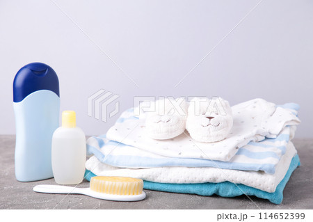 Set of children's clothes for boy on grey background Set of children's clothes for boy on grey background 114652399
