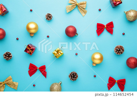 Christmas composition with gold and red decoration on blue background 114652454