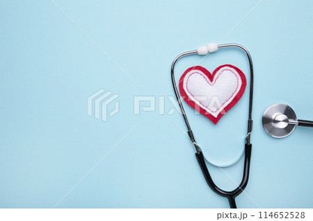 Stethoscope and heart on a blue background. Health, medicine Stethoscope and heart on a blue background. Health, medicine 114652528
