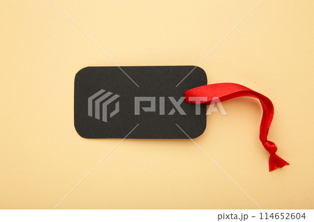 Black sale tag on beige background. Black friday 114652604