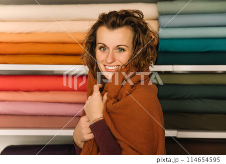 Stylish woman with curly hair in craft textile store, design concept Stylish woman with curly hair in craft textile store, design concept 114654595