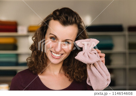Stylish woman with curly hair in craft textile store, design concept Stylish woman with curly hair in craft textile store, design concept 114654608