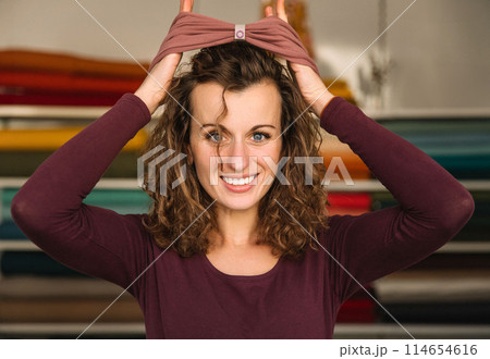 Stylish woman with curly hair in craft textile store, design concept Stylish woman with curly hair in craft textile store, design concept 114654616