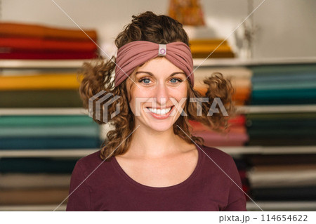 Stylish woman with curly hair in craft textile store, design concept Stylish woman with curly hair in craft textile store, design concept 114654622