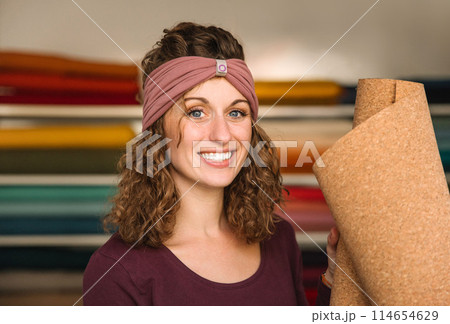 Stylish woman with curly hair in craft textile store, design concept Stylish woman with curly hair in craft textile store, design concept 114654629
