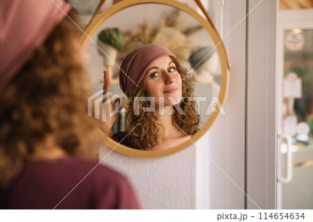 Stylish woman with curly hair in craft textile store, design concept 114654634