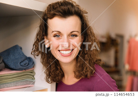 Stylish woman with curly hair in craft textile store, design concept Stylish woman with curly hair in craft textile store, design concept 114654653