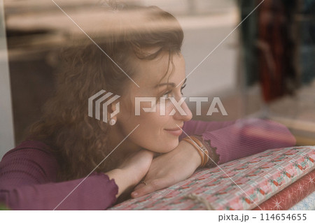 Stylish woman with curly hair in craft textile store, design concept 114654655