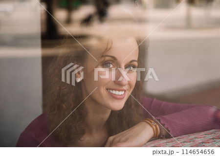 Stylish woman with curly hair in craft textile store, design concept Stylish woman with curly hair in craft textile store, design concept 114654656