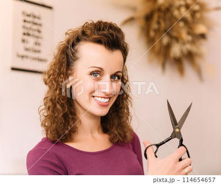 Stylish woman with curly hair in craft textile store, design concept Stylish woman with curly hair in craft textile store, design concept 114654657