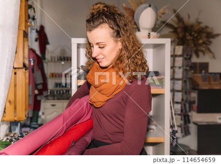 Stylish woman with curly hair in craft textile store, design concept Stylish woman with curly hair in craft textile store, design concept 114654659