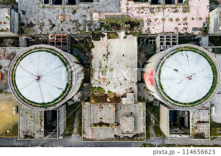 Aerial view from drone of abandoned and ruined Nuclear Power Plant or station, round tower of atomic 114656623