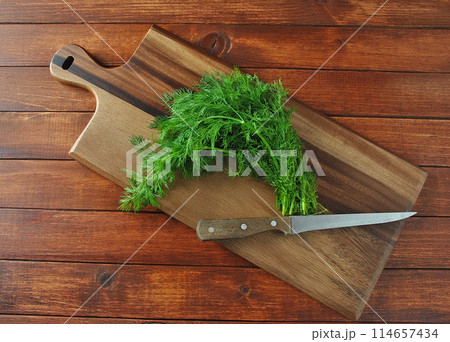 Fresh dill on wooden board. Rustic background 114657434