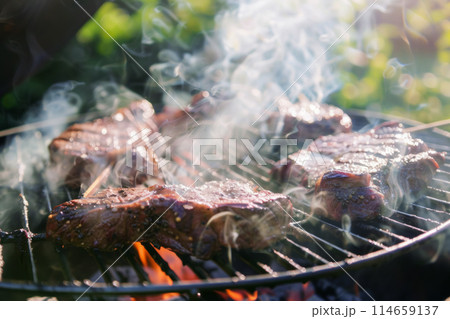 A barbecue party or the essence of summer get-togethers with vibrant photos showcasing ribeye steaks on the grill. Each juicy bite is roasted to perfection, creating a symphony of flavors 114659137