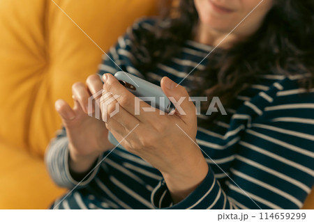 women's hands that confidently hold a smartphone, modern technology women's hands that confidently hold a smartphone, modern technology 114659299