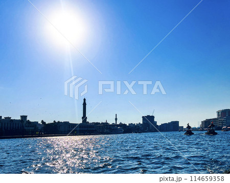 Stylish panoramicview of the historic part of Dubai, against the sun with ships Stylish panoramicview of the historic part of Dubai, against the sun with ships 114659358