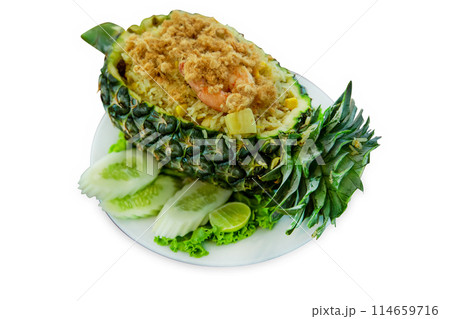 Top view of pineapple fried rice served inside of a pineapple carved like a bowl, focus selective Top view of pineapple fried rice served inside of a pineapple carved like a bowl, focus selective 114659716