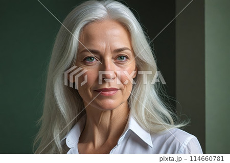 Half-length portrait of a 60-year-old confident and smiling classy female with white hair and green eyes Half-length portrait of a 60-year-old confident and smiling classy female with white hair and green eyes 114660781