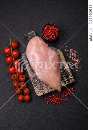 Raw chicken fillet with salt, spices and herbs 114663618